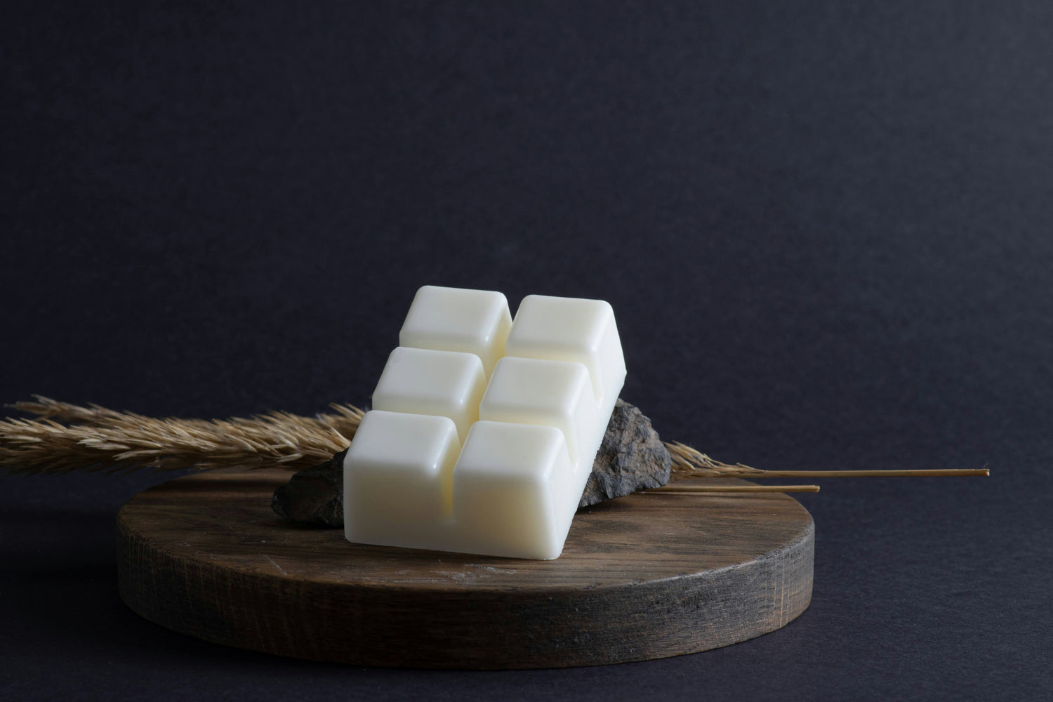 A photo of a wax melt against a dark background